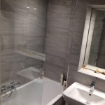 gray bathroom with mirror lighting in Tilehurst, Reading