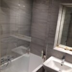 custom bathroom with grey tiled walls in Tilehurst, Reading